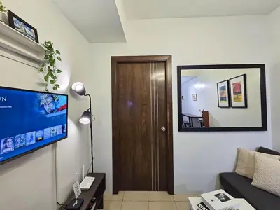 a living room with a couch and a television at 1BR Condotel Ridgewood Towers Near Airport #RW02-1 in Manila