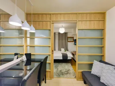 a room with a bed and a room with shelves at 1BR Condotel Ridgewood Towers Near Airport #RW03-1 in Manila