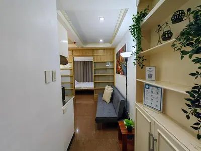 a hallway of a tiny house with a couch and a bedroom at 1BR Condotel Ridgewood Towers Near Airport #RW05-1 in Manila