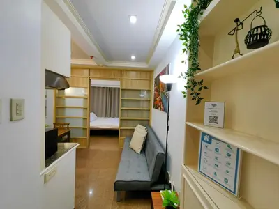 a small room with a couch and a bedroom at 1BR Condotel Ridgewood Towers Near Airport #RW05-1 in Manila