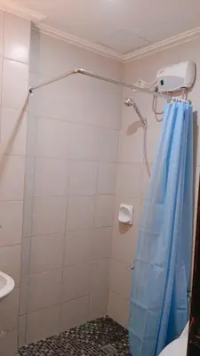 a shower with a blue shower curtain in a bathroom at 1BR Condotel Ridgewood Towers Near Airport #RW05-1 in Manila
