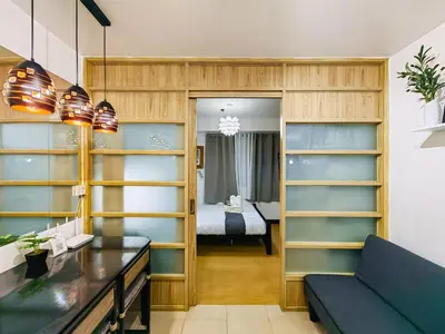 a living room with a couch and a bedroom at 1BR Condotel Ridgewood Towers Near Airport #RW04-1 in Manila