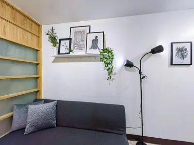 a living room with a couch and a lamp at 1BR Condotel Ridgewood Towers Near Airport #RW04-1 in Manila