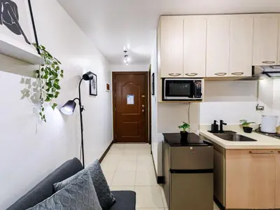a small kitchen with a couch in a small apartment at 1BR Condotel Ridgewood Towers Near Airport #RW04-1 in Manila