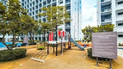 a playground with a slide in front of a building at MOA Staycation at Shore 2 Residences Tower 3 in Manila