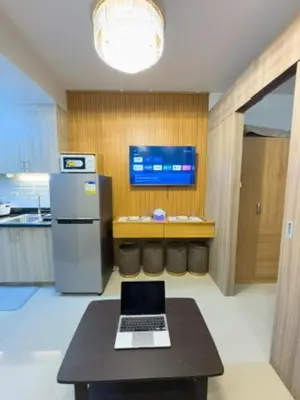 a kitchen with a table with a laptop on it at MOA Staycation at Shore 2 Residences Tower 3 in Manila