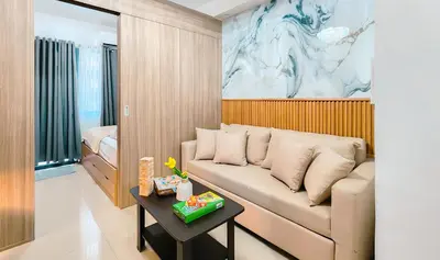 a living room with a couch and a table at MOA Staycation at Shore 2 Residences Tower 3 in Manila