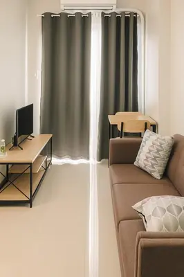 a living room with a couch and a table at Relax Condotel in Manila