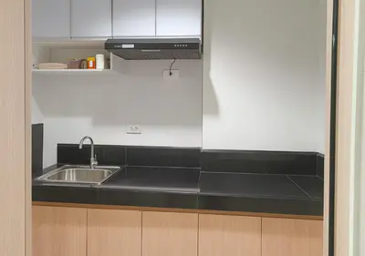 a kitchen with a sink and a counter top at Relax Condotel in Manila