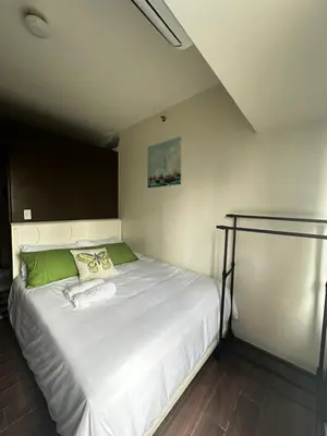 a bedroom with a large white bed in a room at MyScape at Air Residences Makati in Manila
