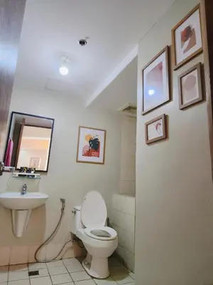 a bathroom with a toilet and a sink at 2BR 90sqm Furnished Condo Shaw Blvd, Mandaluyong in Manila