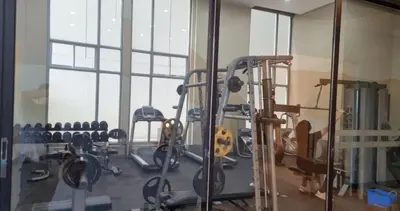 a gym with cardio equipment and a large window at 2BR 90sqm Furnished Condo Shaw Blvd, Mandaluyong in Manila