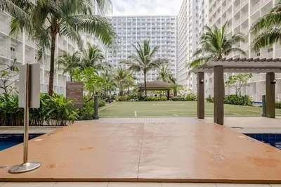 a tennis court in the middle of a building at Hotel Like Staycation Near Airport and MOA Porongs Oasis in Manila