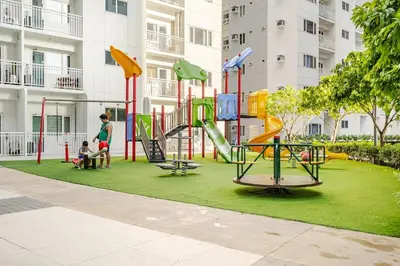 a playground in front of a apartment building at Hotel Like Staycation Near Airport and MOA Porongs Oasis in Manila