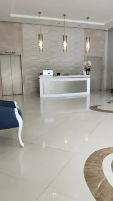 a lobby with a reception desk in a building at Rose150newportpasay in Manila