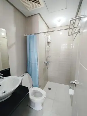 a bathroom with a toilet and a sink at JennieRose150newportpasay in Manila