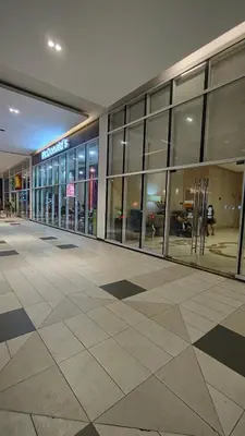 a large building with glass windows in a mall at JennieRose150newportpasay in Manila