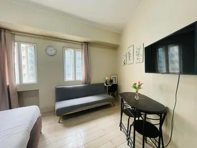 a living room with a couch and a table at JennieRosecondo150newportpasay in Manila