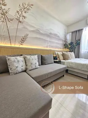 a living room with two beds and a couch at Modern Unit at Shore 2 Mall of Asia by Elle Suite in Manila