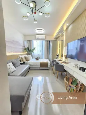 a living room with a bed and a living area at Modern Unit at Shore 2 Mall of Asia by Elle Suite in Manila