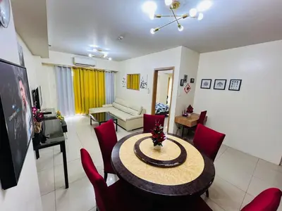 a living room with a table and red chairs at Unit 958 B Shell Residences 2br in Manila