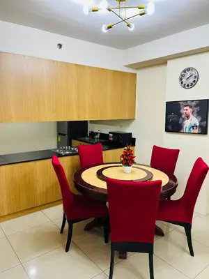 a dining room with a table and red chairs at Unit 958 B Shell Residences 2br in Manila