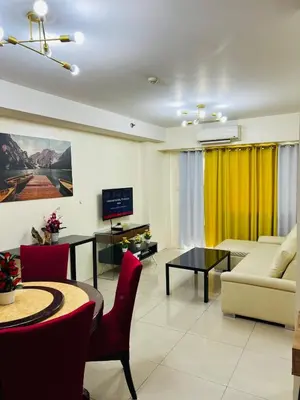 a living room with a couch and a table at Unit 958 B Shell Residences 2br in Manila