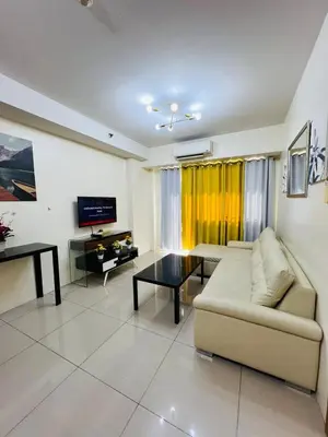 a living room with a couch and a table at Unit 958 B Shell Residences 2br in Manila