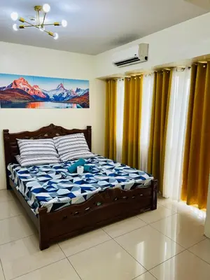 a bedroom with a bed with a teddy bear on it at Unit 958 B Shell Residences 2br in Manila