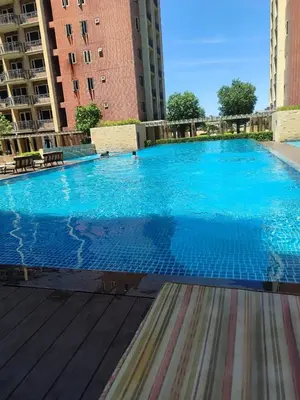 a large blue swimming pool with buildings in the background at Condo near Moa with Pool Access WS1205 in Manila