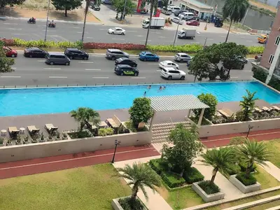 an aerial view of a parking lot with a large pool at Condo near Moa with Pool Access WS1205 in Manila
