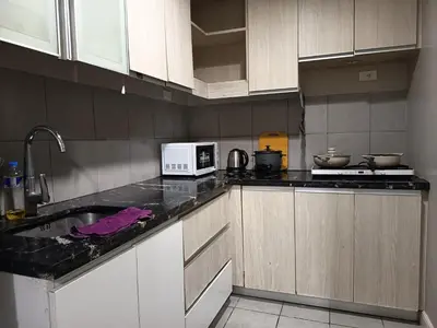 a kitchen with a sink and a microwave on a counter at Condo near Moa with Pool Access WS1205 in Manila