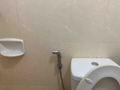 a bathroom with a toilet and a water hose at Avant at the Fort 360 City Center views in BGC Taguig w Pool Access in Manila