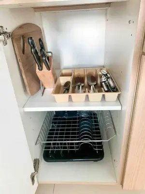 a cupboard filled with lots of kitchen utensils at Avant at the Fort 360 City Center views in BGC Taguig w Pool Access in Manila