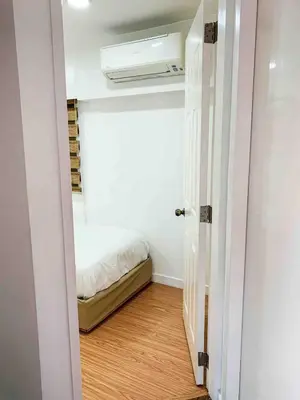 a small bedroom with a bed and a window at 2BR Condo w Pool Loft at Fort Victoria BGC Taguig in Manila