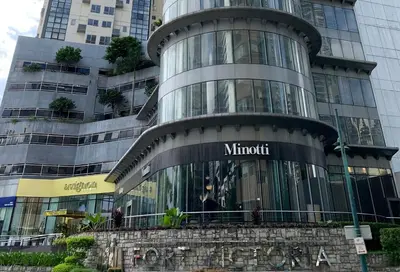 a large building with a sign on the side of it at 2BR Condo w Pool Loft at Fort Victoria BGC Taguig in Manila