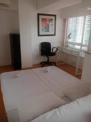a bedroom with a bed and a desk and a chair at 2BR Condo w Pool Loft at Fort Victoria BGC Taguig in Manila