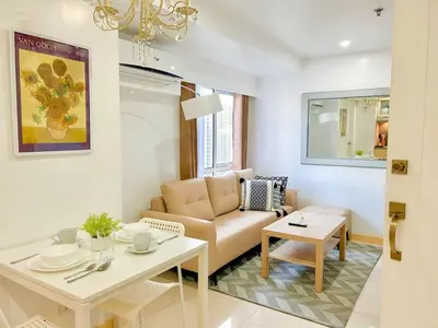 a living room with a couch and a table at 2bedroom Loft Apartment within BGC in Manila