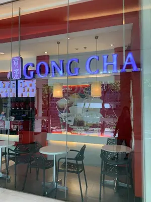 a person walking into a store window with tables and chairs at 2bedroom Loft Apartment within BGC in Manila