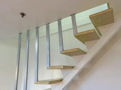 a staircase in a house with glass railing at 2bedroom Loft Apartment within BGC in Manila