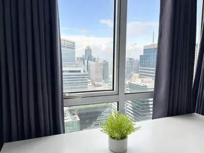 a window with a potted plant in front of it at 2bedroom Loft Apartment within BGC in Manila