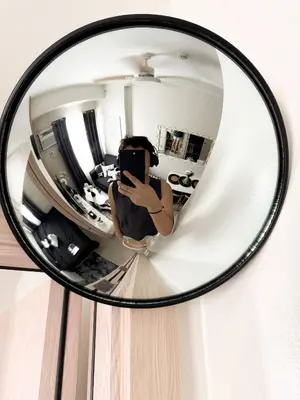 a woman taking a picture of herself in a mirror at Nap & Go Staycation in Manila