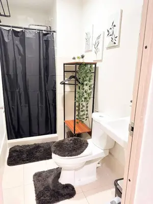 a bathroom with a toilet and a sink and a shower at Nap & Go Staycation in Manila