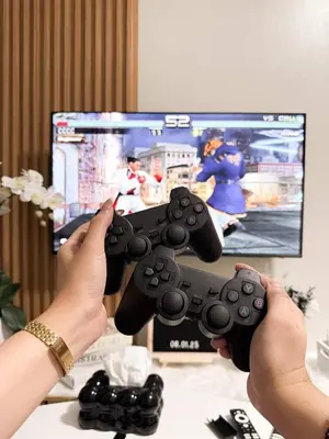 a person holding a video game controller in front of a tv at Nap & Go Staycation in Manila