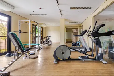 a gym with several treadmills and exercise bikes at Self-Checkin - Piekny Dom - A Beautiful Home in Manila