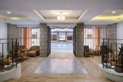 a lobby with chairs and tables in a building at Self-Checkin - Piekny Dom - A Beautiful Home in Manila