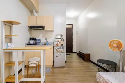 a small kitchen with a counter and a refrigerator at Self-Checkin - Piekny Dom - A Beautiful Home in Manila