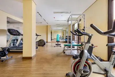 a gym with several treadmills and exercise bikes at Self-Checkin - Piekny Dom - A Beautiful Home in Manila