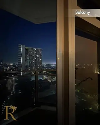 a view of a city at night from a building at The Radiance Manila Bay - DF Sy 19J in Manila