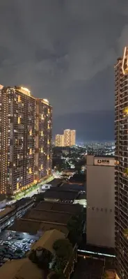 a view of a city at night with tall buildings at 1Bedroom2603A Sunshine100Tower3 70Inches TV Pool Karaoke in Manila